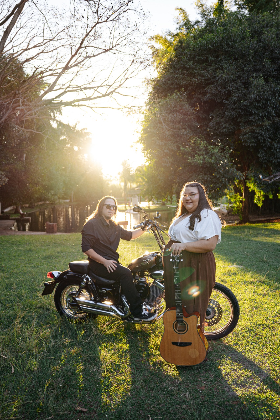 Evelyn e Felipi com violão e motocicleta